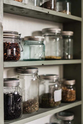 Glass jars are stored in kitchen space